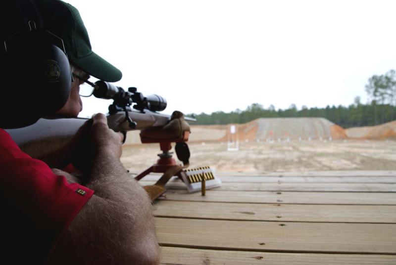Man looking down rifle sight at McHenry Range