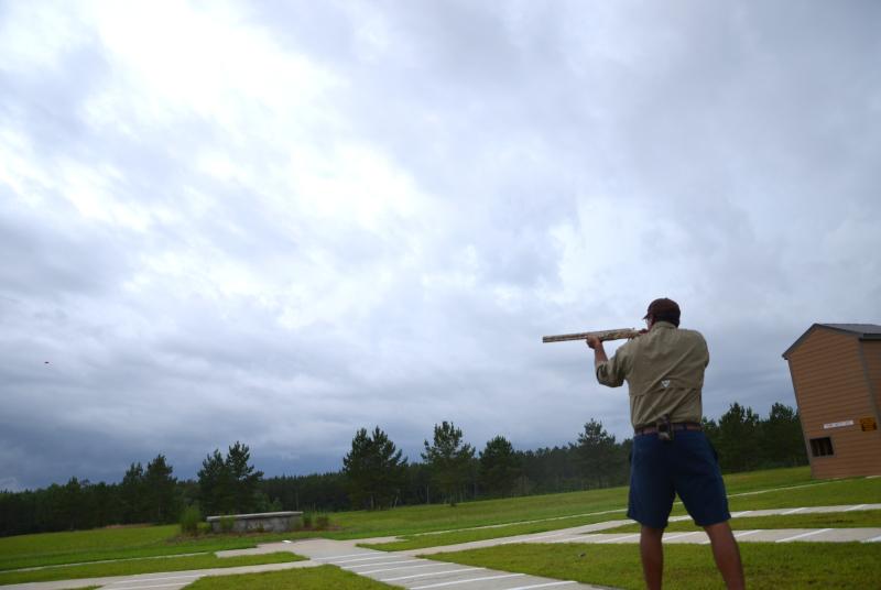Man sighting target under cloudy sky at McHenry Range