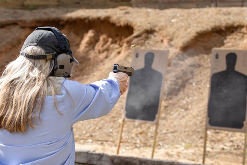 Female shooting a handgun at Turcotte Shooting Facility